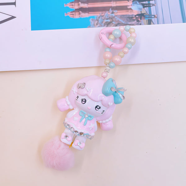 Velvet Whispers: Hand-Painted Chibi Charm with Fluffy Pom-Pom Accents